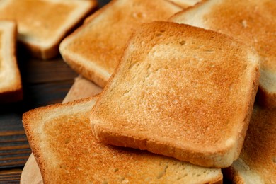 Slices of tasty toasted bread on table, closeup
