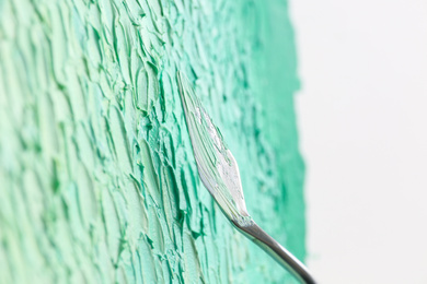 Abstract colorful artwork painting with spatula, closeup view