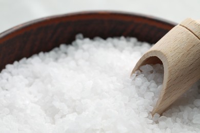 Natural sea salt in wooden bowl and scoop, closeup