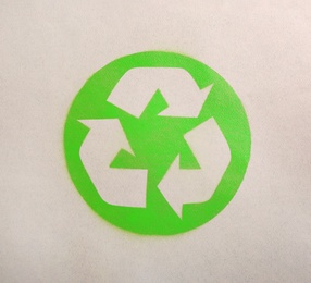 Recycling symbol on cardboard paper, top view