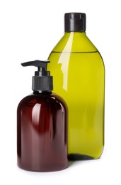 Different bottles of shampoo on white background