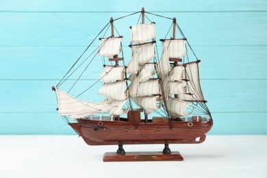 Beautiful ship model on white wooden table