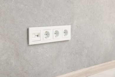 Wall with power outlet sockets in room. Interior design