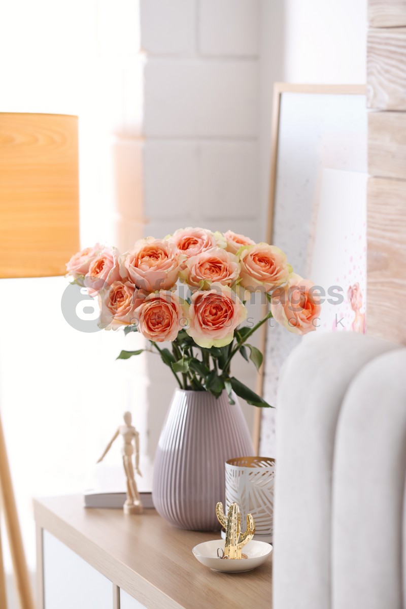 Vase with beautiful flowers in modern room interior