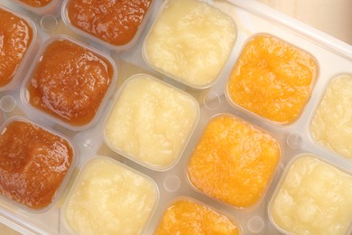 Different purees in ice cube tray, top view. Ready for freezing