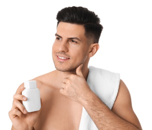 Handsome man with stubble holding post shave lotion on white background