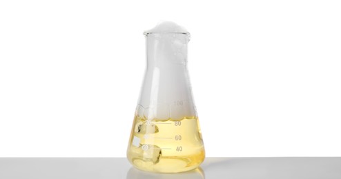 Photo of Laboratory flask with colorful liquid isolated on white. Chemical reaction