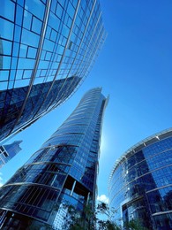 Low angle view of modern business complex under blue sky