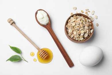 Photo of Composition of ingredients for handmade face mask on white background, top view