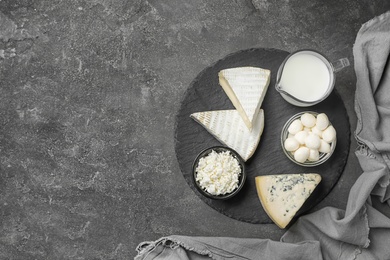 Fresh dairy products on gray background, top view