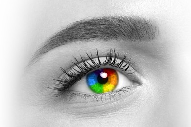 Image of Beautiful woman, closeup. Focus on right eye, iris in rainbow colors