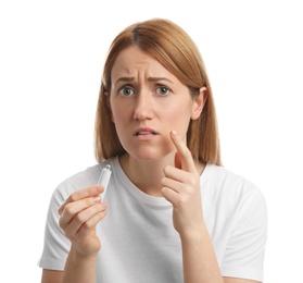 Upset woman with herpes applying cream on lips against white background