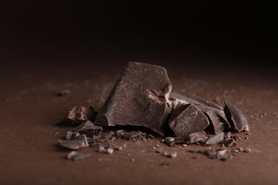Pieces of dark chocolate on brown table