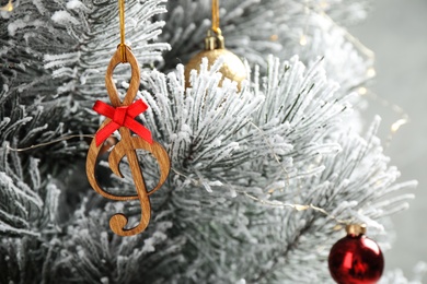 Fir tree with wooden treble clef and decor, closeup view. Christmas music