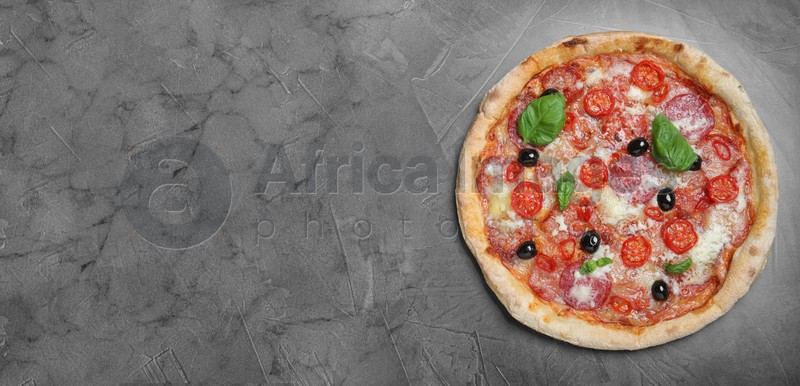 Delicious pizza Diablo on grey table, top view with space for text. Banner design