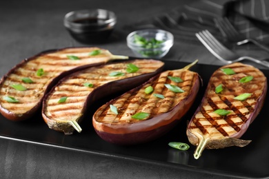 Delicious grilled eggplant halves served on plate, closeup