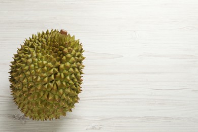 Ripe durian on white wooden table, top view. Space for text