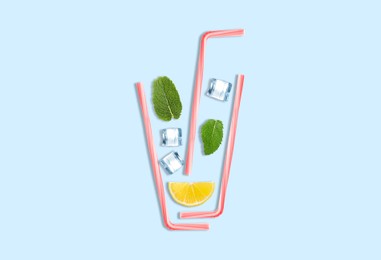 Image of Creative lemonade layout with lemon slice, mint, ice cubes and straws on turquoise background, top view