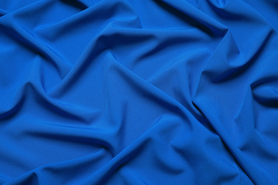 Photo of Crumpled fabric, top view. Color of the year 2020 (Classic blue)