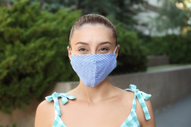 Woman wearing handmade cloth mask outdoors. Personal protective equipment during COVID-19 pandemic