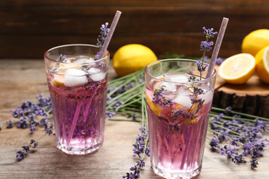 Fresh delicious lemonade with lavender and straws on wooden table
