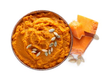 Delicious vegetable puree with pumpkin pieces and seeds on white background, top view. Healthy food