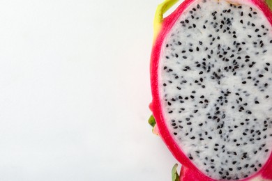 Top view of cut dragon fruit (pitahaya) on white background, closeup. Space for text