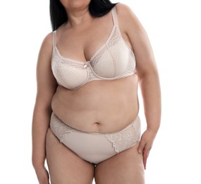Overweight woman in beige underwear on white background, closeup. Plus-size model