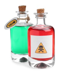 Glass bottles of poisons with warning signs on white background