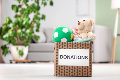 Photo of Donation box with toys on floor indoors