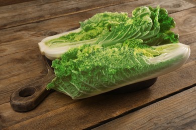 Halves of fresh ripe Chinese cabbage on wooden table