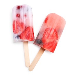 Tasty berry popsicles on white background, top view