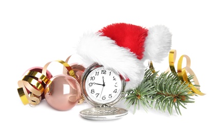 Pocket watch with Santa hat and festive decor on white background. New Year countdown