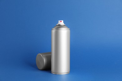 Can of spray paint on blue background