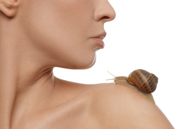 Photo of Beautiful young woman with snail on her shoulder 
 against white background, closeup
