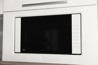 Photo of Modern microwave oven built in kitchen furniture