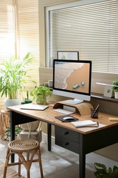 Light room interior with comfortable workplace near window