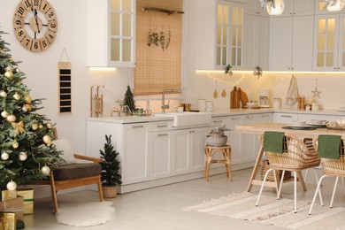 Cozy open plan kitchen decorated for Christmas. Interior design
