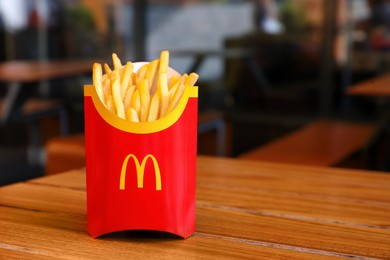 MYKOLAIV, UKRAINE - AUGUST 11, 2021: Big portion of McDonald's French fries on table in cafe. Space for text