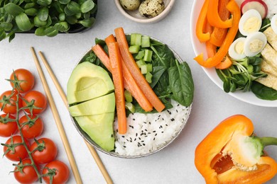 Photo of Delicious poke bowl and ingredients on light grey background, flat lay