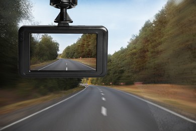 Modern dashboard camera mounted in car, view of road during driving