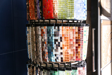 Photo of Samples of different mosaic tiles in store. Total wholesale
