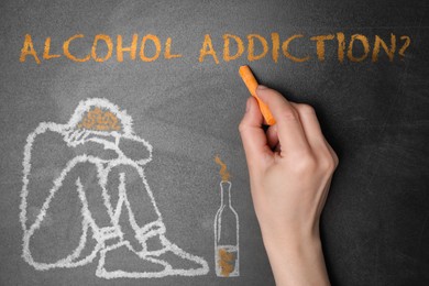 Alcohol addiction? - We can help you. Closeup view of woman writing with chalk on blackboard