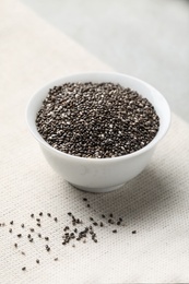 Photo of Bowl with chia seeds on light grey table
