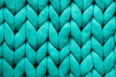 Turquoise knitted wool texture as background, top view