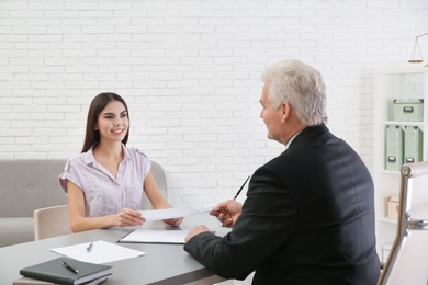 Young woman having meeting with lawyer in office