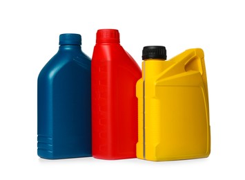 Motor oil in different containers on white background