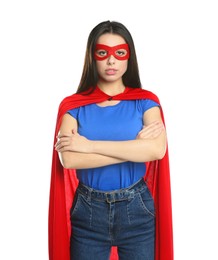 Confident young woman wearing superhero cape and mask on white background