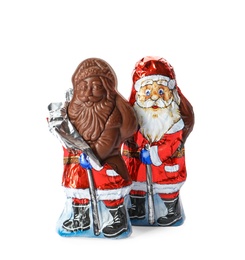 Sweet chocolate Santa Claus candies in foil wrappers on white background