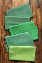 Different kitchen napkins on wooden table, flat lay